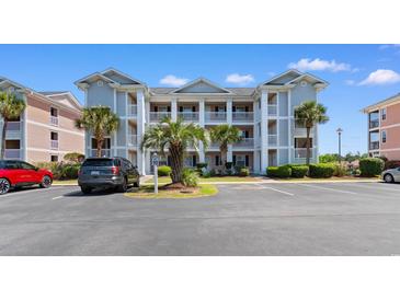 A bright, multi-story condo building with classic white pillars and lush palms in a well-maintained community at 608 Waterway Village Blvd. # 27-F, Myrtle Beach, SC 29579