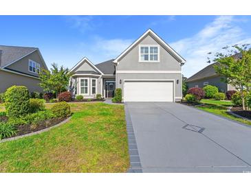 Charming home featuring a well-maintained lawn, a two-car garage, and a welcoming entrance at 809 Covelo Ln., Myrtle Beach, SC 29579