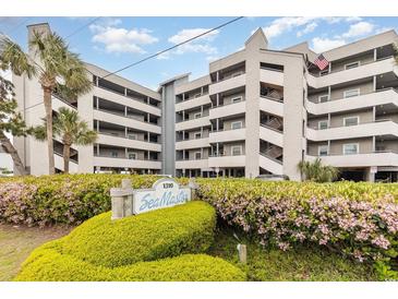 Beautifully landscaped condo complex with mature plants and views from multiple levels at 1310 N Waccamaw Dr. # 211, Garden City Beach, SC 29576