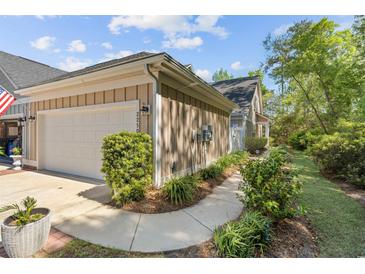 Charming home featuring a one car garage, nice landscaping, and beige siding at 2250 Heritage Loop, Myrtle Beach, SC 29577