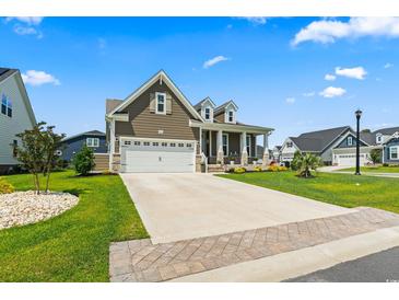 Charming two-story home featuring a two-car garage and a well-manicured front yard in a desirable neighborhood at 5000 Azul Loop, Myrtle Beach, SC 29579