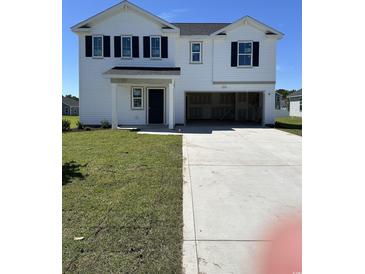 A charming two-story white home with black shutters, inviting front door, and an attached garage at 1028 Kinness Dr., Conway, SC 29527