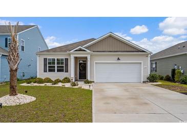 Inviting single-Gathering home featuring a manicured lawn, a two-car garage, and a welcoming front entrance at 3549 Bells Lake Circle, Longs, SC 29568