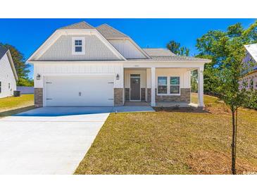 Charming single-story home with a well-manicured lawn, attached garage, and a welcoming front porch at 476 Honeyhill Loop, Conway, SC 29526