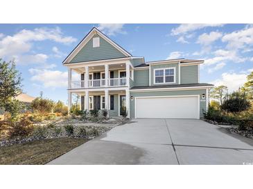Charming two-story home boasts a double porch, attached garage, and beautifully landscaped front yard at 615 Forage Dr, Conway, SC 29526