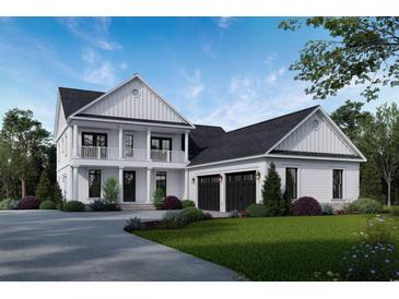 Charming two-story home boasting a welcoming front porch, attached garage, and professionally landscaped yard at 1099 Wachesaw Rd., Murrells Inlet, SC 29576