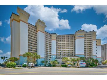 Stunning exterior view of a modern multi-story condo building with a manicured landscape at 4800 S Ocean Blvd. # 708, North Myrtle Beach, SC 29582