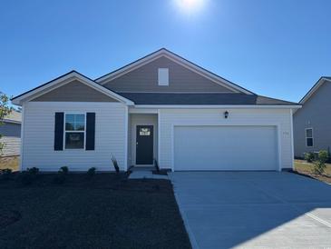 Charming single-Gathering home featuring a one car garage and well manicured lawn at 504 Blissful Ln., Little River, SC 29566