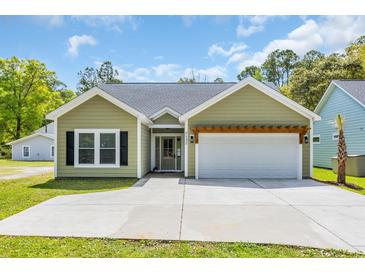 Charming single-story home with a welcoming front entrance and a two-car garage at 5132 Little River Neck Rd., North Myrtle Beach, SC 29582
