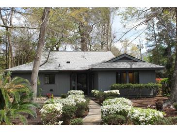 Charming single-story home with mature trees, a well-kept lawn, and beautiful shrubs at 880 Briarwood Dr., Myrtle Beach, SC 29572
