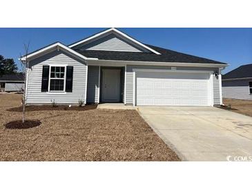 Charming single-story home featuring gray siding, a two-car garage, and a well-manicured lawn at 993 Cherrystone Loop, Conway, SC 29526