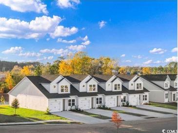 Beautiful new townhomes with attached garages and private driveways, surrounded by a scenic landscape at 1213 American Shad Dr. # 37, Conway, SC 29526