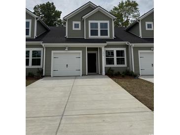 Charming townhome with a two-car garage and well-manicured landscaping at 1213 American Shad Dr. # 37, Conway, SC 29526