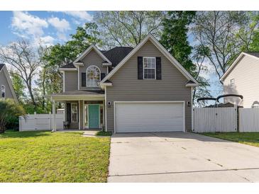 Charming home with a two-car garage, well-kept lawn, and inviting turquoise front door at 237 Chesapeake Ln., Murrells Inlet, SC 29576