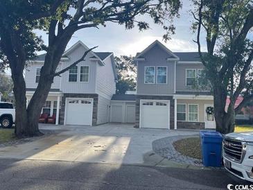 Charming exterior view of two modern two-story homes with attached garages at 2601 Sand Dunes Dr., Myrtle Beach, SC 29577