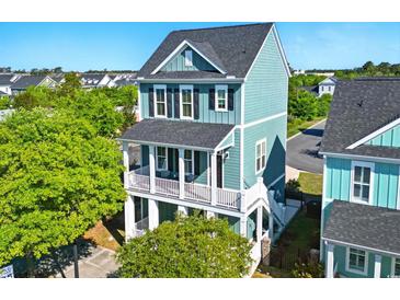 Charming two-story home with double porches, blue siding, and well-manicured landscaping at 524 Farrow Pkwy., Myrtle Beach, SC 29577