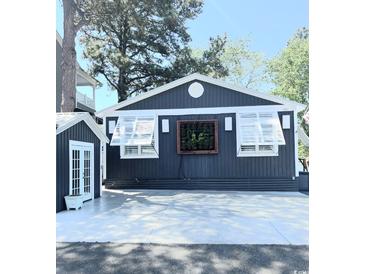 Charming home with a modern design and a lush, green feature on the front wall at 6001-Z55 South Kings Hwy., Myrtle Beach, SC 29575