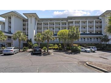 Beautiful condo building with parking and manicured landscaping features multiple floors and beach access at 601 Retreat Beach Circle # 215, Pawleys Island, SC 29585