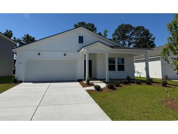 Charming, newly constructed two-story white home with a well-manicured lawn and attached garage at 1027 Laconic Dr., Myrtle Beach, SC 29588