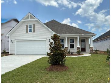 Charming single-story home with a two-car garage, well-manicured lawn, and inviting front entrance at 1051 Laconic Dr., Myrtle Beach, SC 29588