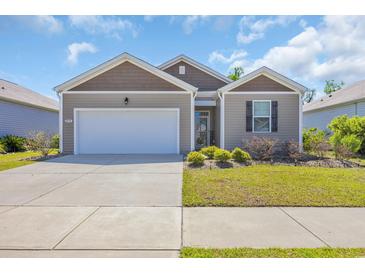 Charming single-story home with a well-maintained lawn, attached garage, and classic architectural details at 2771 Eclipse Dr., Myrtle Beach, SC 29577