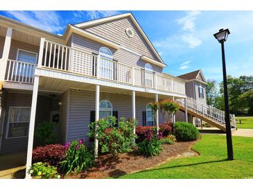 Beautiful condo exterior with spacious balcony, lush landscaping, and well-maintained grounds on a sunny day at 110 Portsmith Dr. # 8, Myrtle Beach, SC 29588