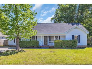 Charming single-story home with a lush green lawn, trimmed hedges, and a welcoming front porch at 202 Berkshire Dr., Myrtle Beach, SC 29588