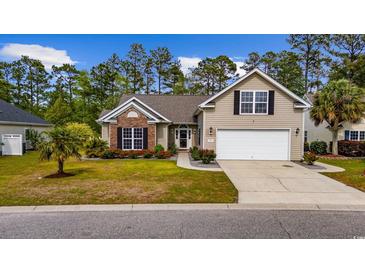 Charming home with well-manicured lawn, flowering shrubs, and a two-car garage at 293 Hillsborough Dr., Conway, SC 29526