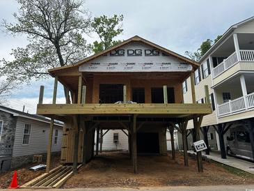 Under-construction home featuring a two-story design with wood framing and a raised foundation showcasing its potential at 6001 - 5142 S Kings Hwy., Myrtle Beach, SC 29575