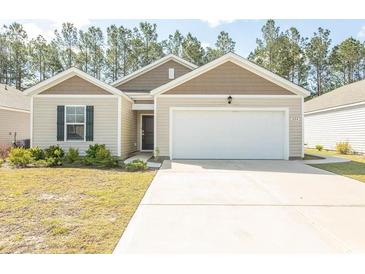 Charming one-story home with a well-manicured lawn and a two-car garage at 884 Freestyle Ct., Longs, SC 29568