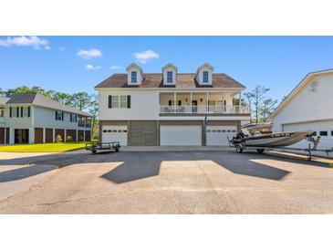 Charming two-story home with a spacious driveway and boat parking, perfect for waterfront living at 1030 Fork Retch Ct., Mullins, SC 29574