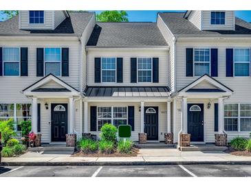 Attractive townhome exterior featuring neutral siding, black shutters, and a well-maintained lawn at 104 Barnacle Ln. # 3, Little River, SC 29566