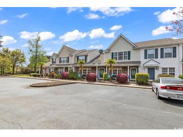 Well maintained townhome featuring manicured landscaping, palm trees and plenty of parking for residents and guests at 1046 Palisade Circle # 1046, Myrtle Beach, SC 29577