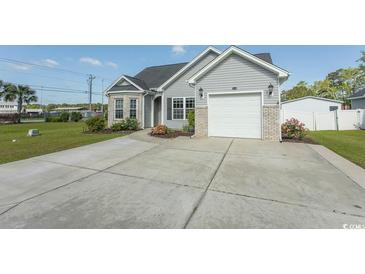 Charming home with gray siding, a spacious driveway, and attached garage at 107 Carolines Cove Ct., Myrtle Beach, SC 29588