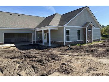 New construction home with an open garage and a covered front porch and fresh landscaping potential at 135 Stonewall Circle # 7-2, Longs, SC 29568