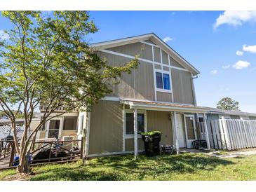 Charming two-story home with neutral siding, white trim, and a well-maintained lawn on a sunny day at 1411 Turkey Ridge Rd. # 30-B, Surfside Beach, SC 29575