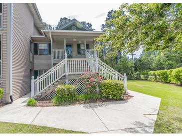 Charming condo with a quaint front porch, white railings, and beautiful landscaping at 227 Pinehurst Ln. # 6D, Pawleys Island, SC 29585