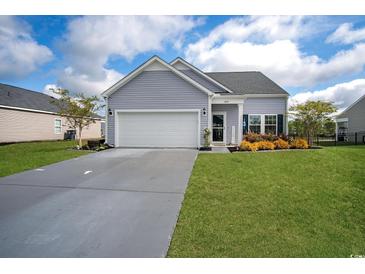 Charming single-Gathering home featuring a well-manicured lawn, attached garage, and beautiful curb appeal at 5039 Gladstone Dr, Conway, SC 29526