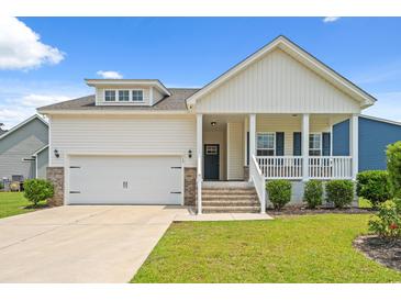 Charming home with a covered porch, garage, and well-maintained lawn at 512 Charlton Blvd., Georgetown, SC 29440
