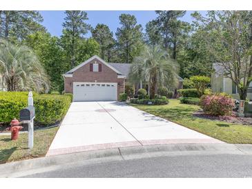 Charming brick home featuring a well-manicured lawn, a spacious driveway, and a two-car garage at 6486 Somersby Dr., Murrells Inlet, SC 29576