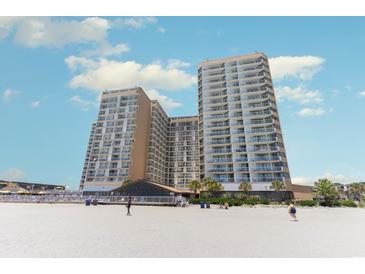 Stunning exterior view of beachfront condo complex with a pristine sandy beach at 9550 Shore Dr. # 633, Myrtle Beach, SC 29572