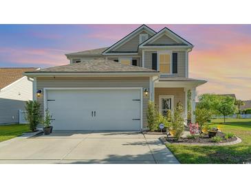 Charming two-story home featuring a two-car garage, manicured lawn, and beautiful landscaping at 1313 Cascarilla Ct., Myrtle Beach, SC 29579