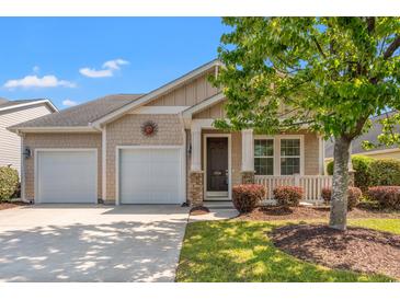 Charming single-story home featuring a two-car garage, covered porch, and well-maintained landscaping at 1524 Culbertson Ave., Myrtle Beach, SC 29577