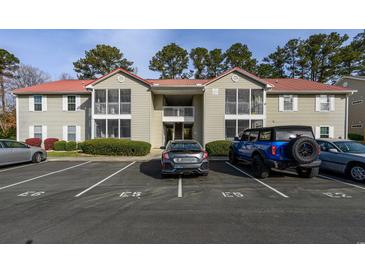 Well-maintained condo building featuring private balconies, manicured landscaping, and convenient parking at 193 Charter Dr. # E-2, Longs, SC 29568