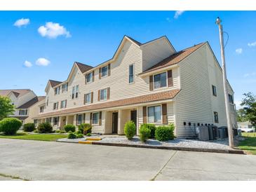 Townhouse exterior with tan siding, brown shutters, and landscaping at 510 Fairwood Lakes Dr. # 16-I, Myrtle Beach, SC 29588