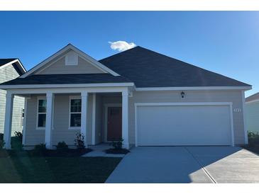 Charming single-story home featuring a two-car garage, well-maintained lawn, and craftsman-style design at 532 Duvall St., Longs, SC 29568