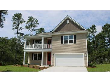 Two-story home featuring a two-car garage and a charming front porch on both levels at 880 Ireland Dr., Longs, SC 29568