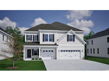 Charming two-story home with a three-car garage, classic siding, and a well-manicured lawn, providing a welcoming curb appeal at 1118 Laconic Dr., Myrtle Beach, SC 29588
