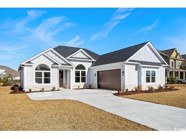 Charming single-story home with a two-car garage and well manicured landscaping at 163 Sago Palm Dr., Myrtle Beach, SC 29579