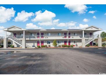 Two-story building with white brick, purple doors and parking lot at 3170 Holmestown Rd., Myrtle Beach, SC 29588